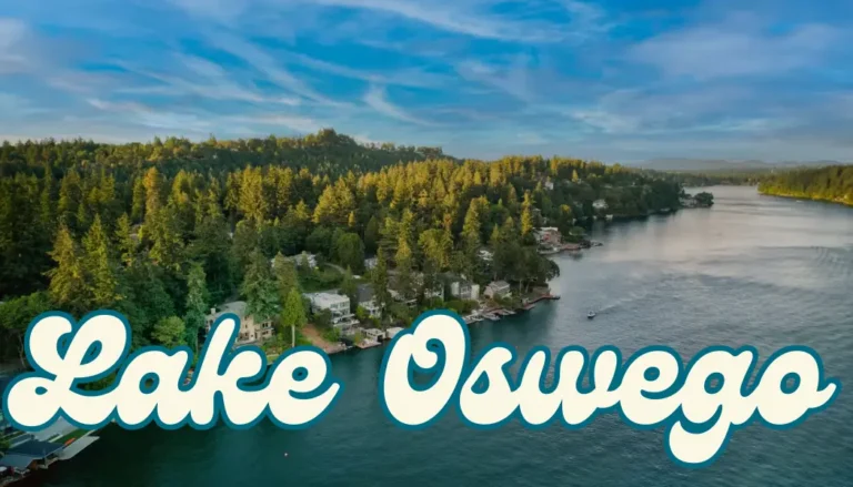 View of Oswego Lake with homes and forested shoreline.