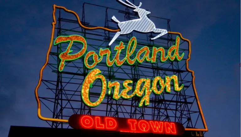 Urban skyline of Portland with White Stag neon sign.